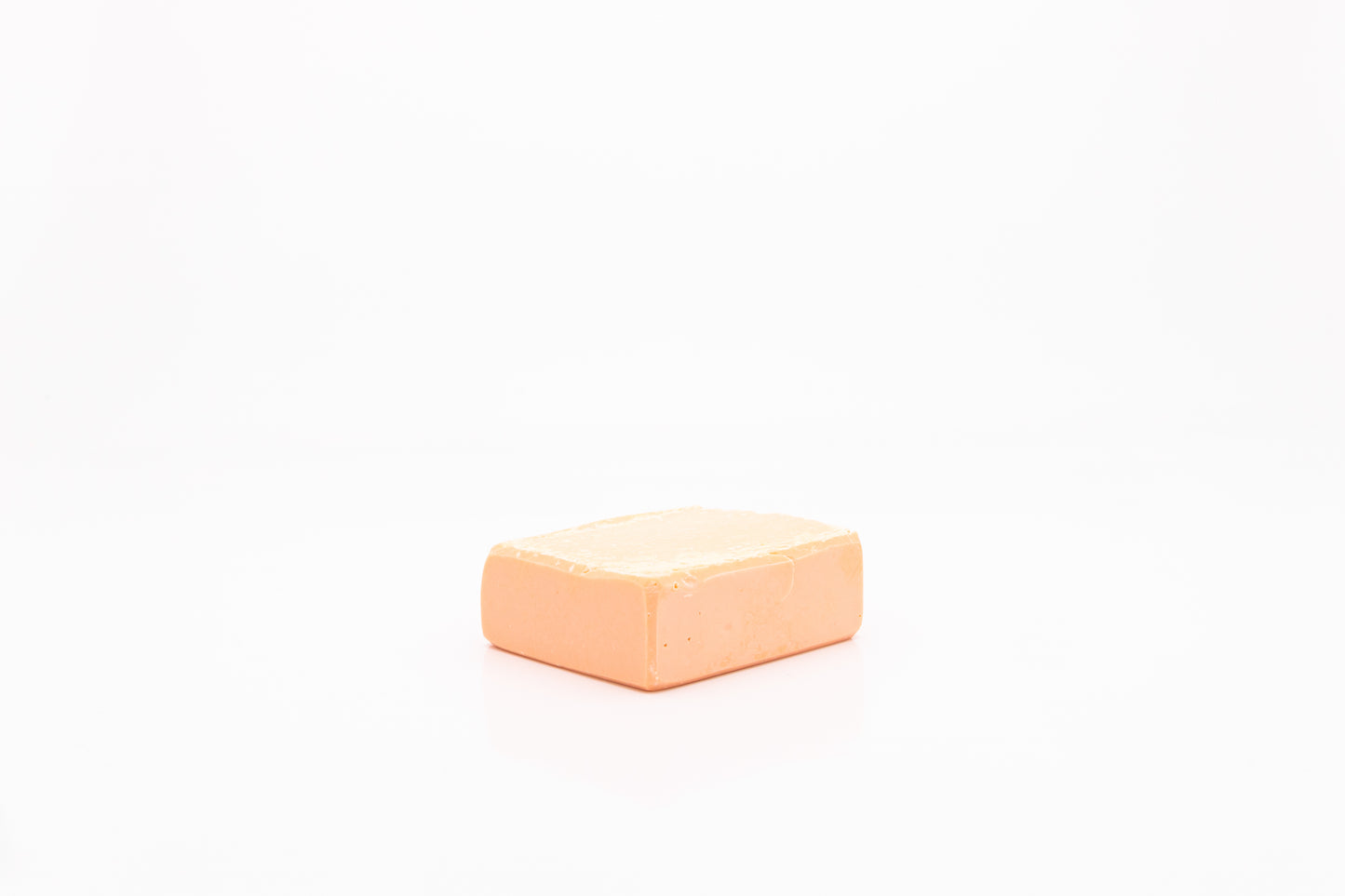 Peach colored, vegan facial cleansing bar.