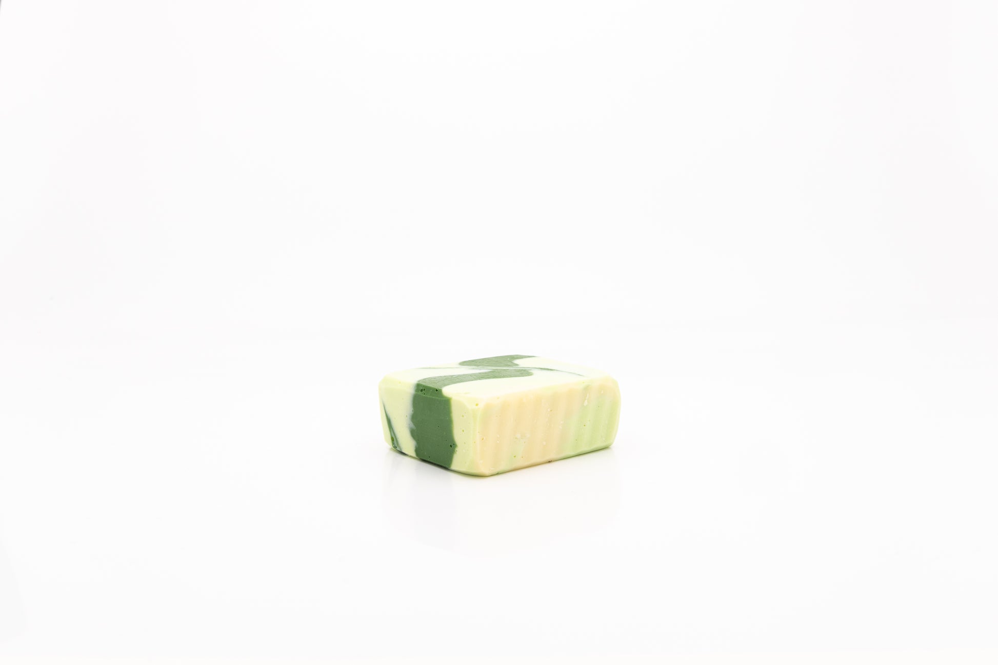 White and green colored vegan facial cleansing bar. 